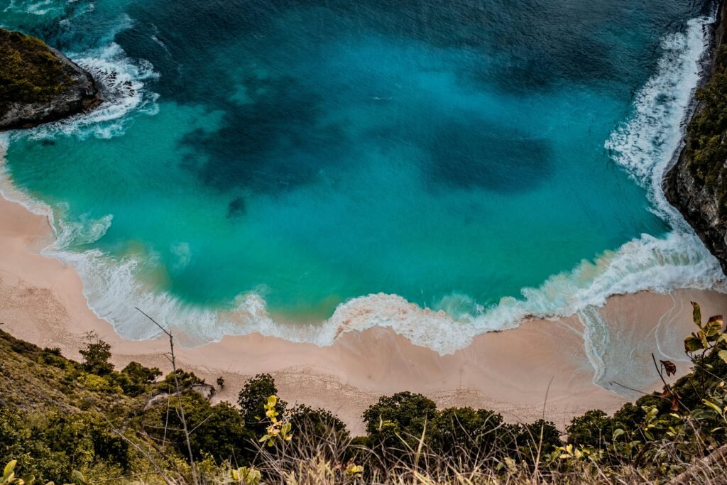 A breathtaking aerial shot capturing a turquoise beach with vibrant waves in Bali, Indonesia.